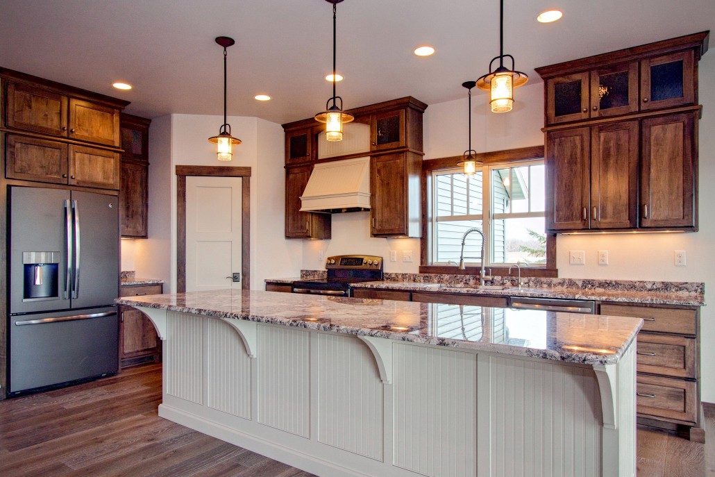 HDR real estate photograph of a bright kitchen with a granite island